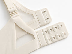 White detail view - back hook-and-eye closure and adjustable strap